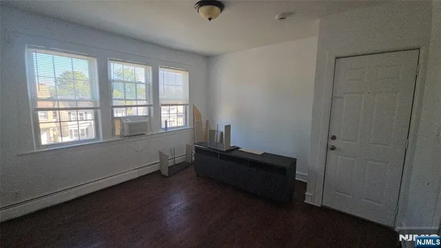 a view of a hallway with a wooden floor