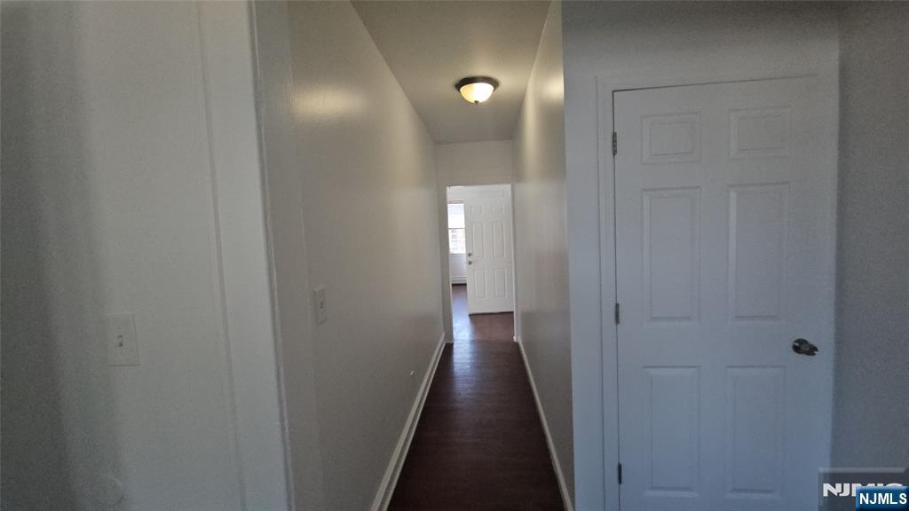 264-266 Pomona Avenue, Unit 3 Newark, NJ 07112 - Photo 9 of 27 a view of a hallway with a wooden floor
