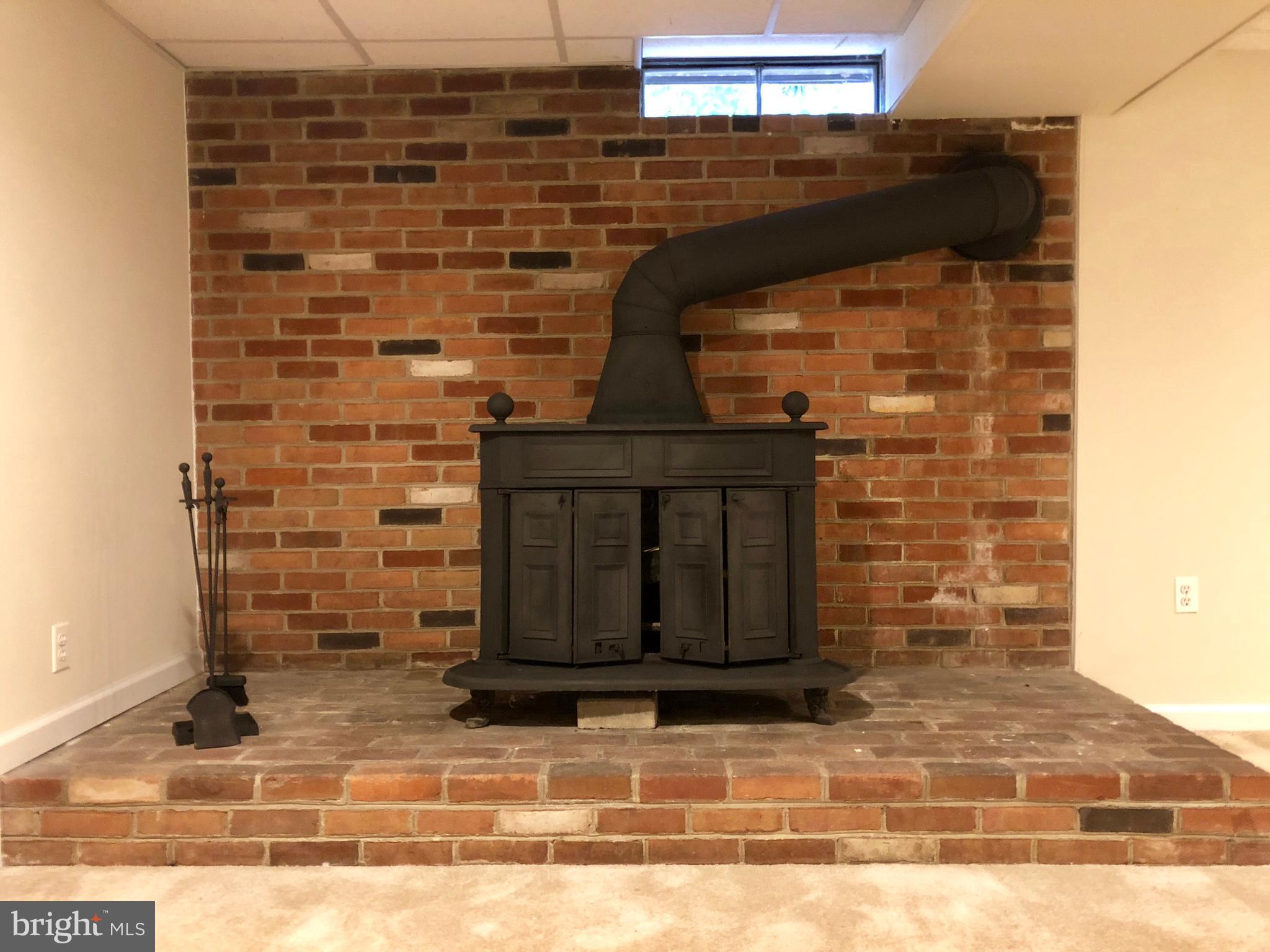 10919 Rawley Road New Market, MD 21774 - Photo 11 of 15 LOWER LEVEL WITH WOOD STOVE AND OUTDOOR ACCESS