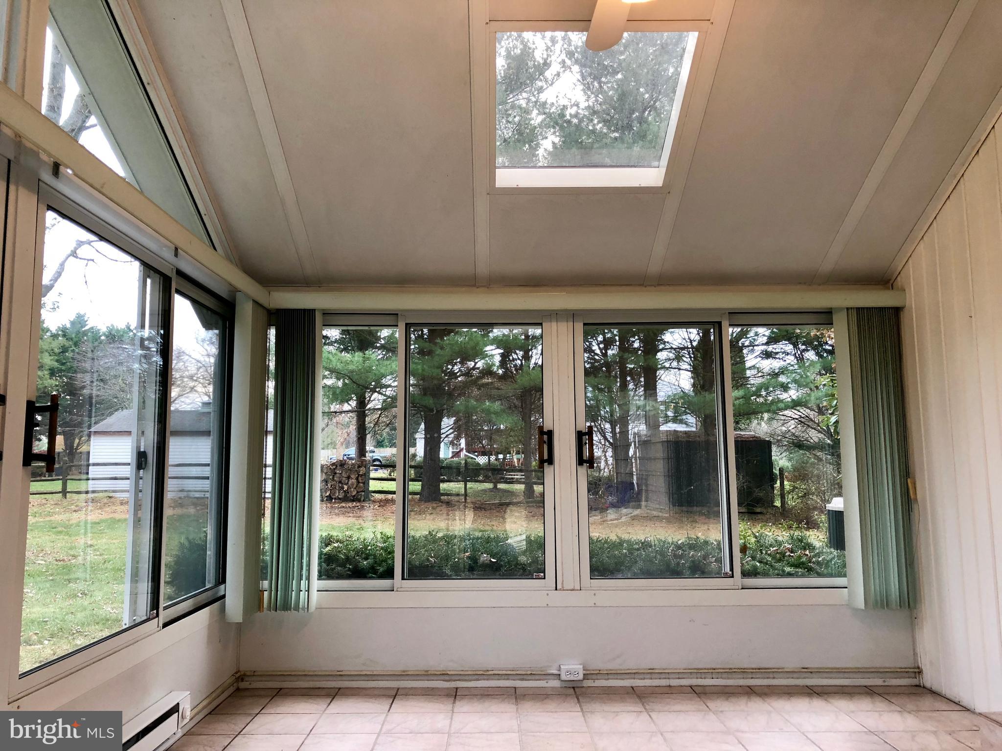 10919 Rawley Road New Market, MD 21774 - Photo 8 of 15 SUNROOM WITH CEILING FAN AND SLIDER TO YARD