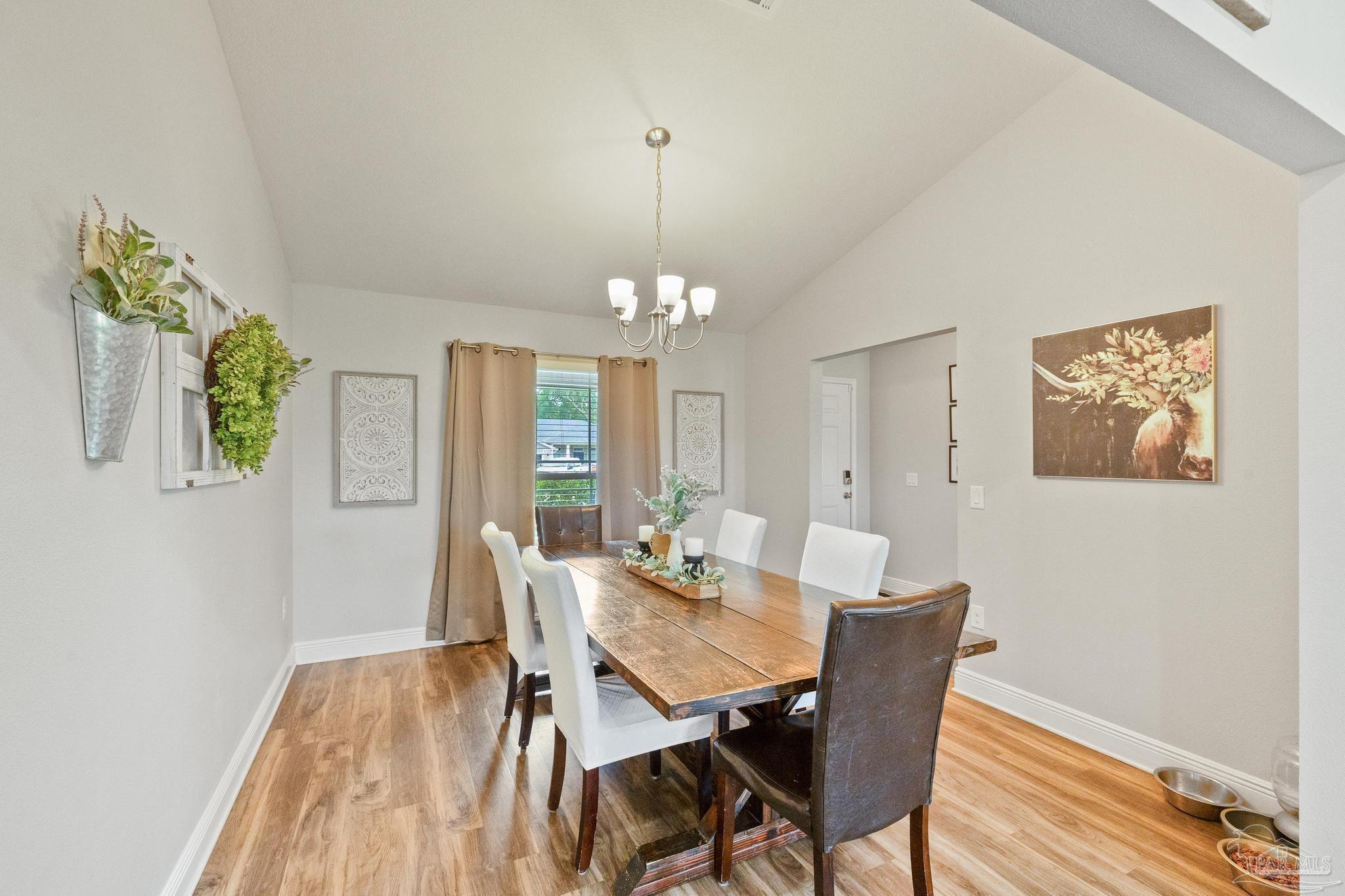 4037 Millwright Way Pace, FL 32571 - Photo 14 of 46 a view of a dining room with furniture window and wooden floor