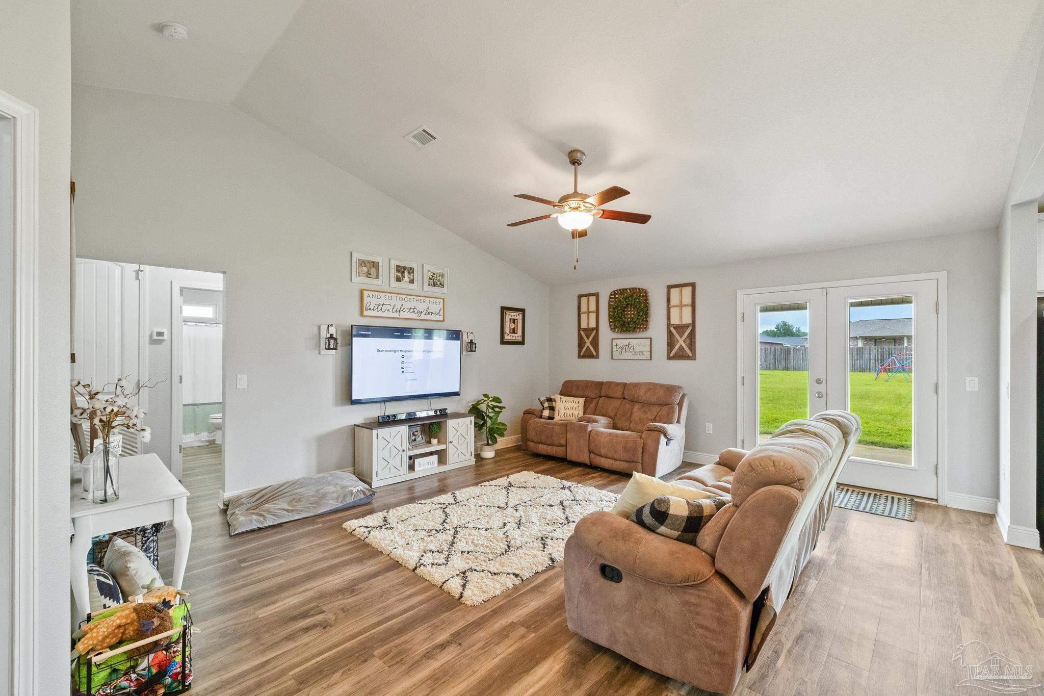 4037 Millwright Way Pace, FL 32571 - Photo 17 of 46 a living room with furniture and wooden floor