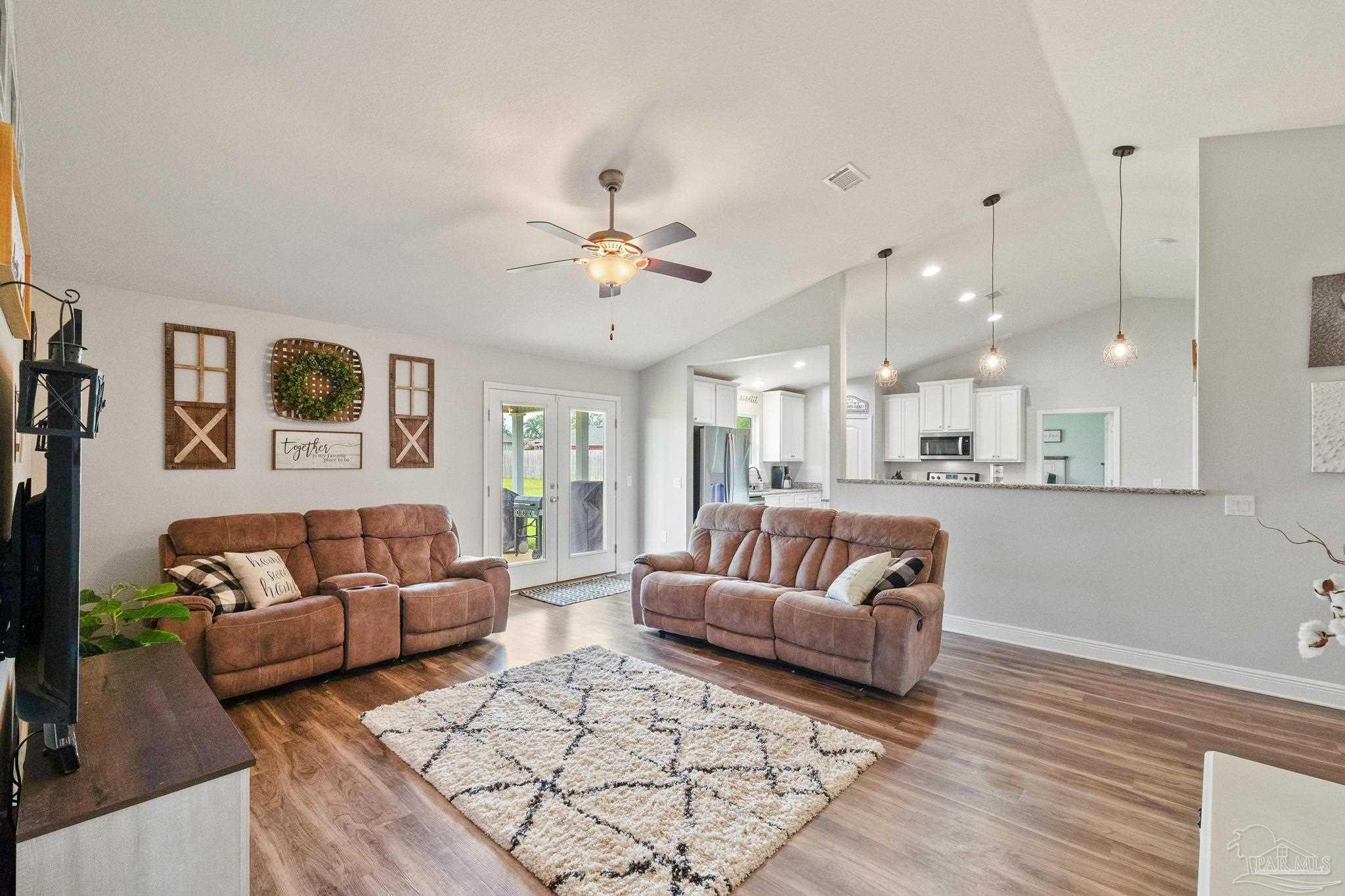 4037 Millwright Way Pace, FL 32571 - Photo 18 of 46 a living room with furniture and a view of kitchen