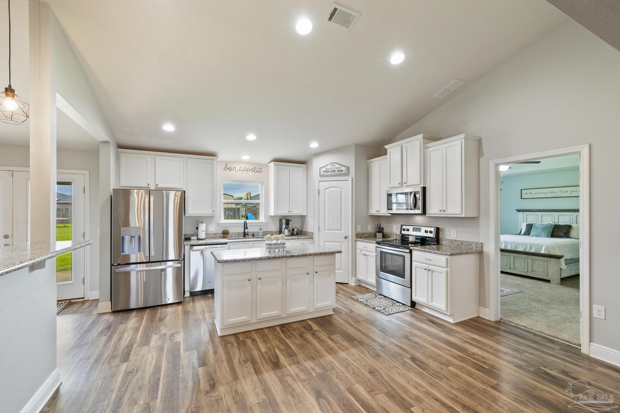 4037 Millwright Way Pace, FL 32571 - Photo 20 of 46 a kitchen with stainless steel appliances granite countertop a refrigerator and a stove top oven