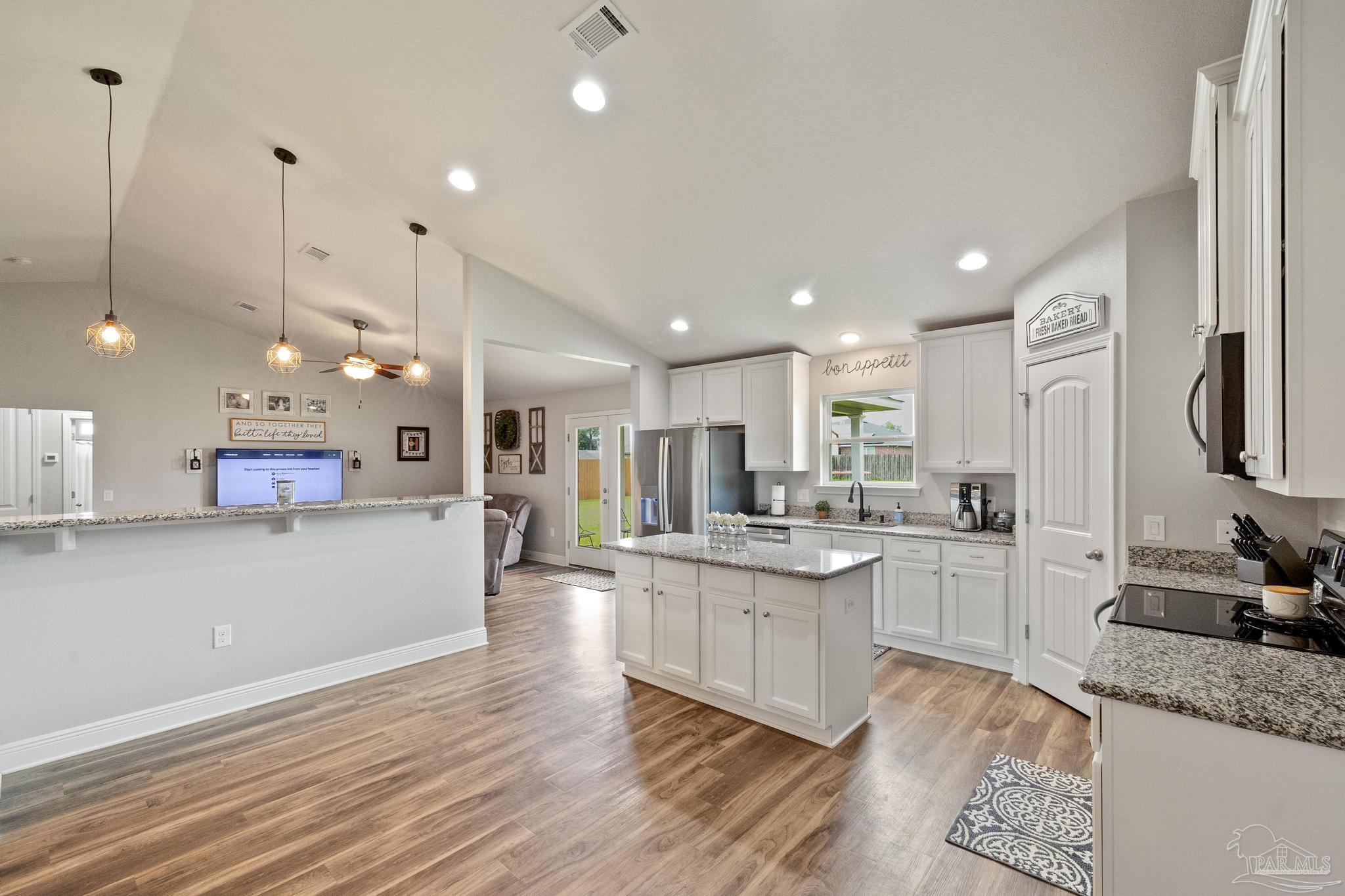 4037 Millwright Way Pace, FL 32571 - Photo 21 of 46 a large kitchen with a large counter top appliances and cabinets