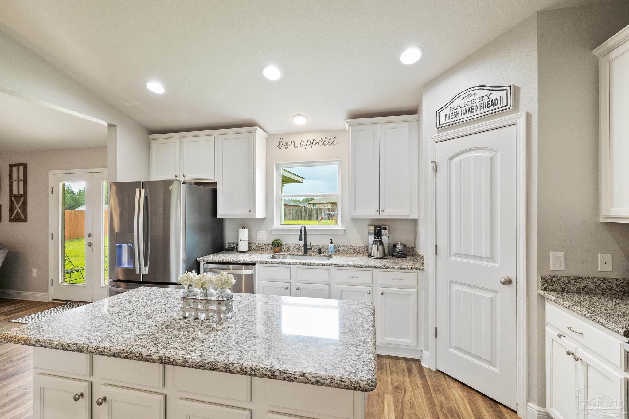 4037 Millwright Way Pace, FL 32571 - Photo 22 of 46 a kitchen with stainless steel appliances granite countertop a sink refrigerator and cabinets