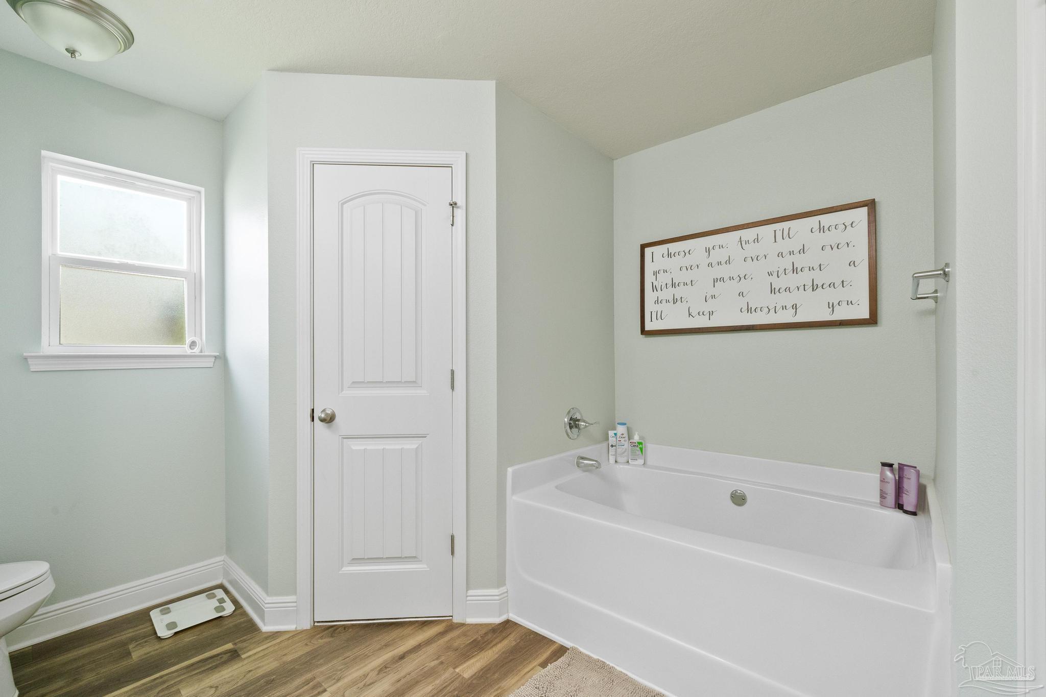 4037 Millwright Way Pace, FL 32571 - Photo 29 of 46 a bathroom with a bathtub and a window