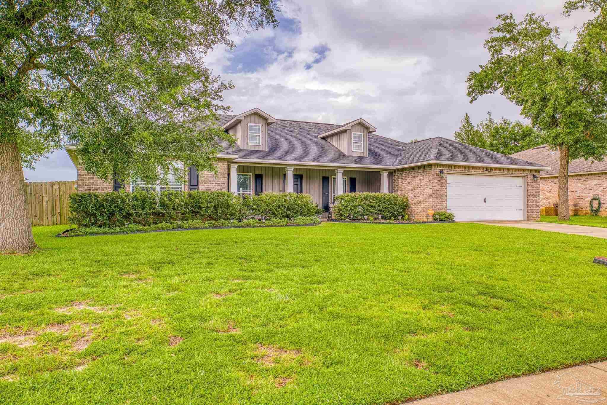 4037 Millwright Way Pace, FL 32571 - Photo 3 of 46 a front view of a house with garden