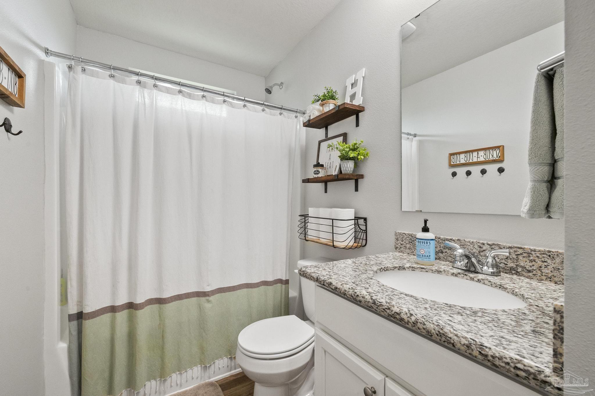 4037 Millwright Way Pace, FL 32571 - Photo 31 of 46 a bathroom with a granite countertop sink and a mirror