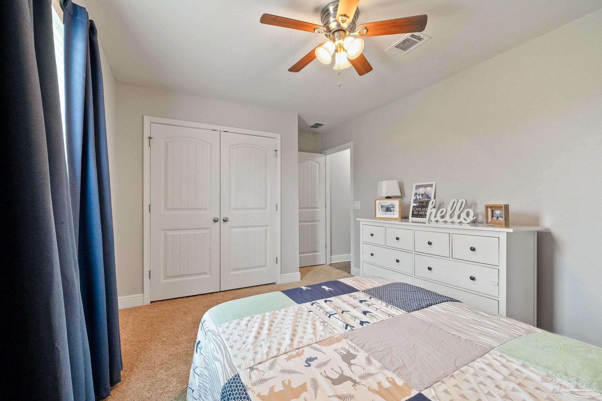 4037 Millwright Way Pace, FL 32571 - Photo 33 of 46 a bedroom with a bed and a chandelier