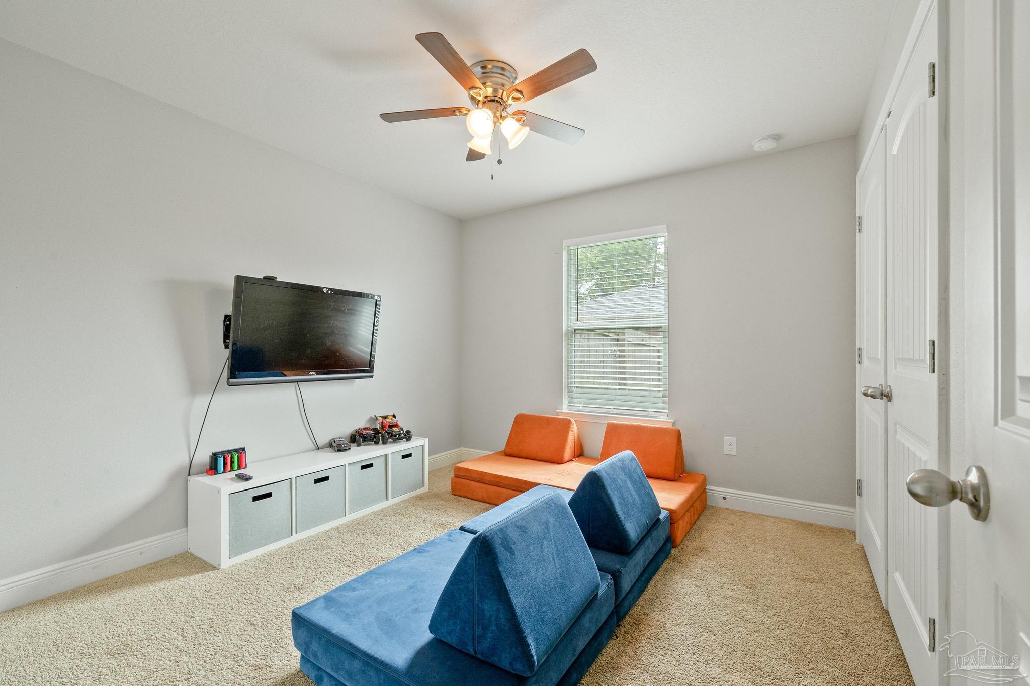 4037 Millwright Way Pace, FL 32571 - Photo 34 of 46 a bedroom with a bed and a flat screen tv