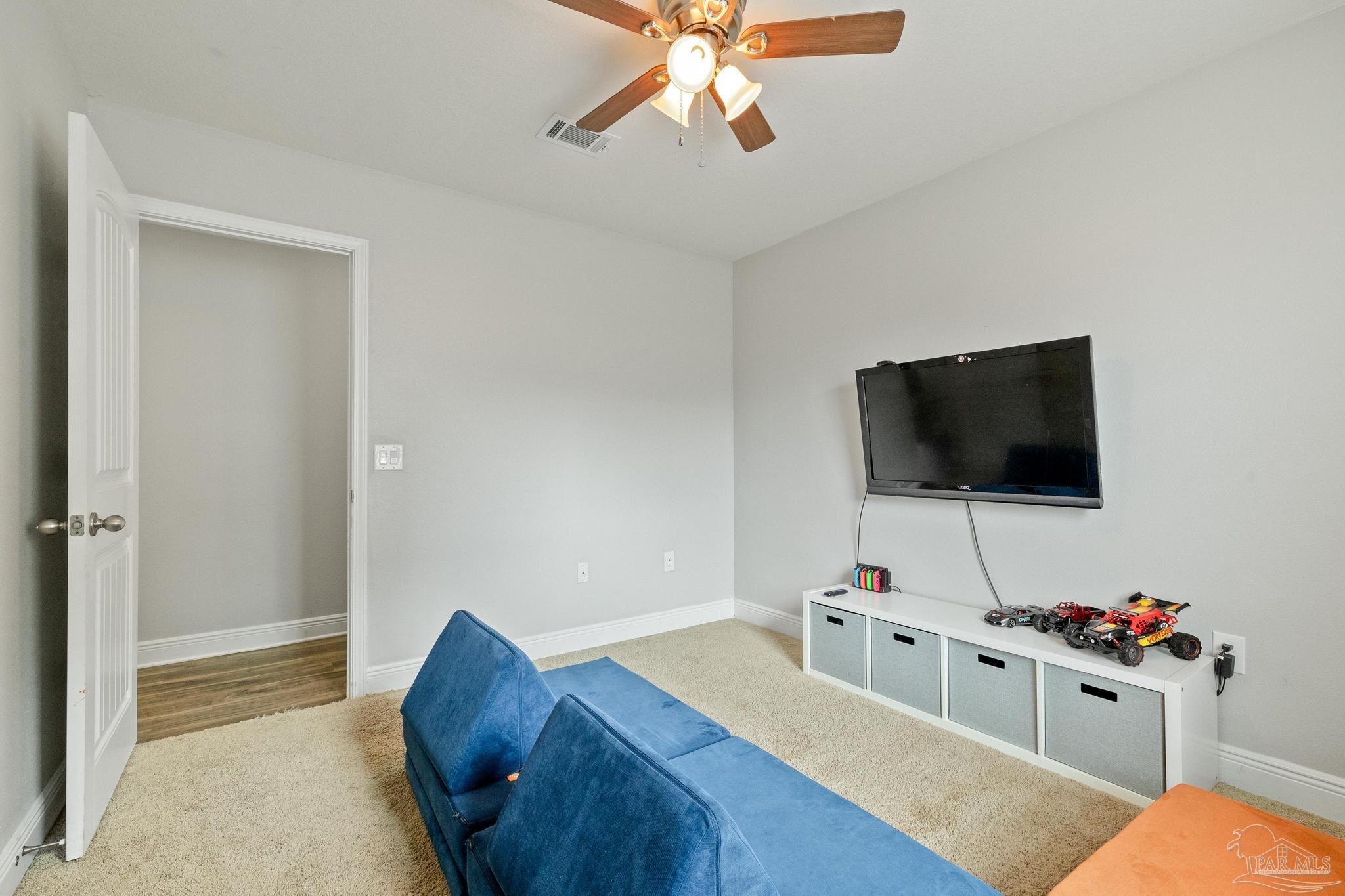 4037 Millwright Way Pace, FL 32571 - Photo 35 of 46 a living room with furniture and a flat screen tv