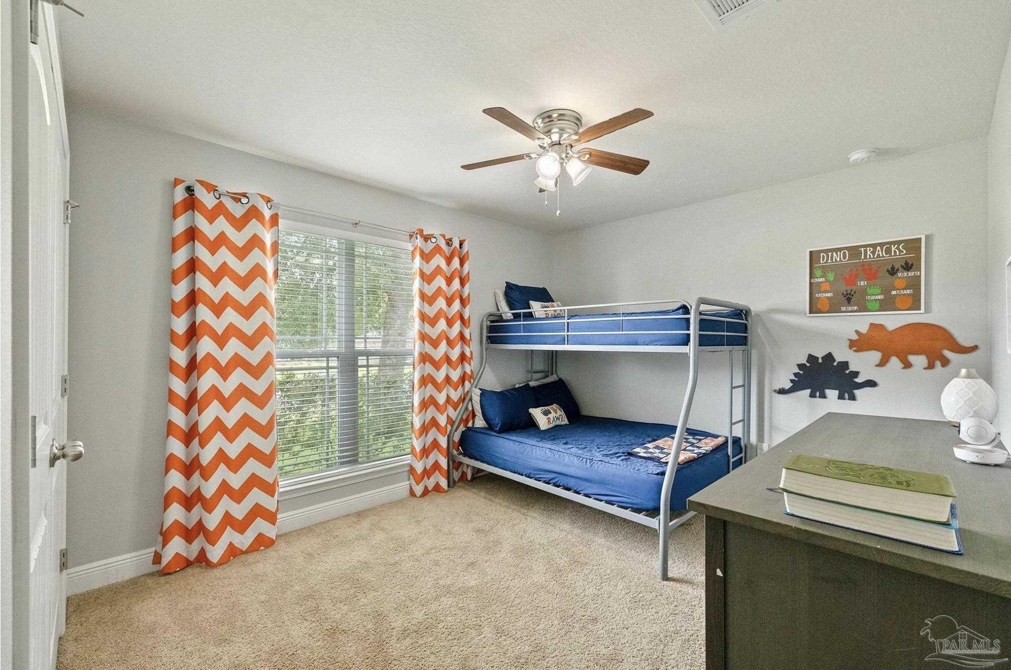 4037 Millwright Way Pace, FL 32571 - Photo 36 of 46 a living room with a baby crib furniture and a chandelier