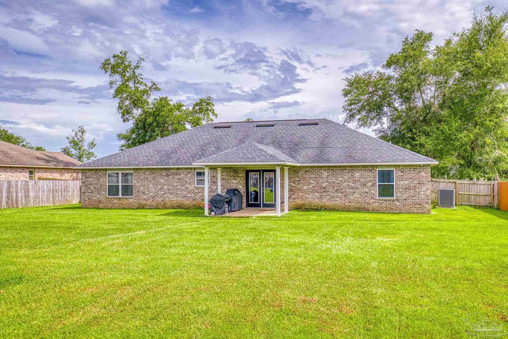 4037 Millwright Way Pace, FL 32571 - Photo 41 of 46 a view of a house with a yard and sitting area