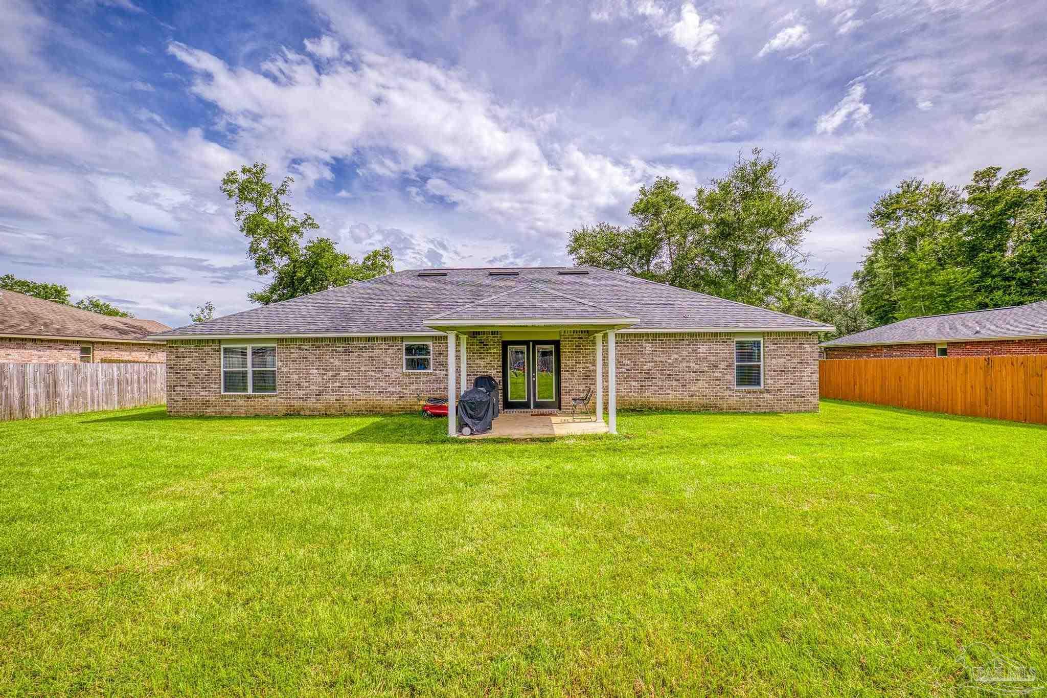 4037 Millwright Way Pace, FL 32571 - Photo 42 of 46 a view of a house with a big yard and a large tree