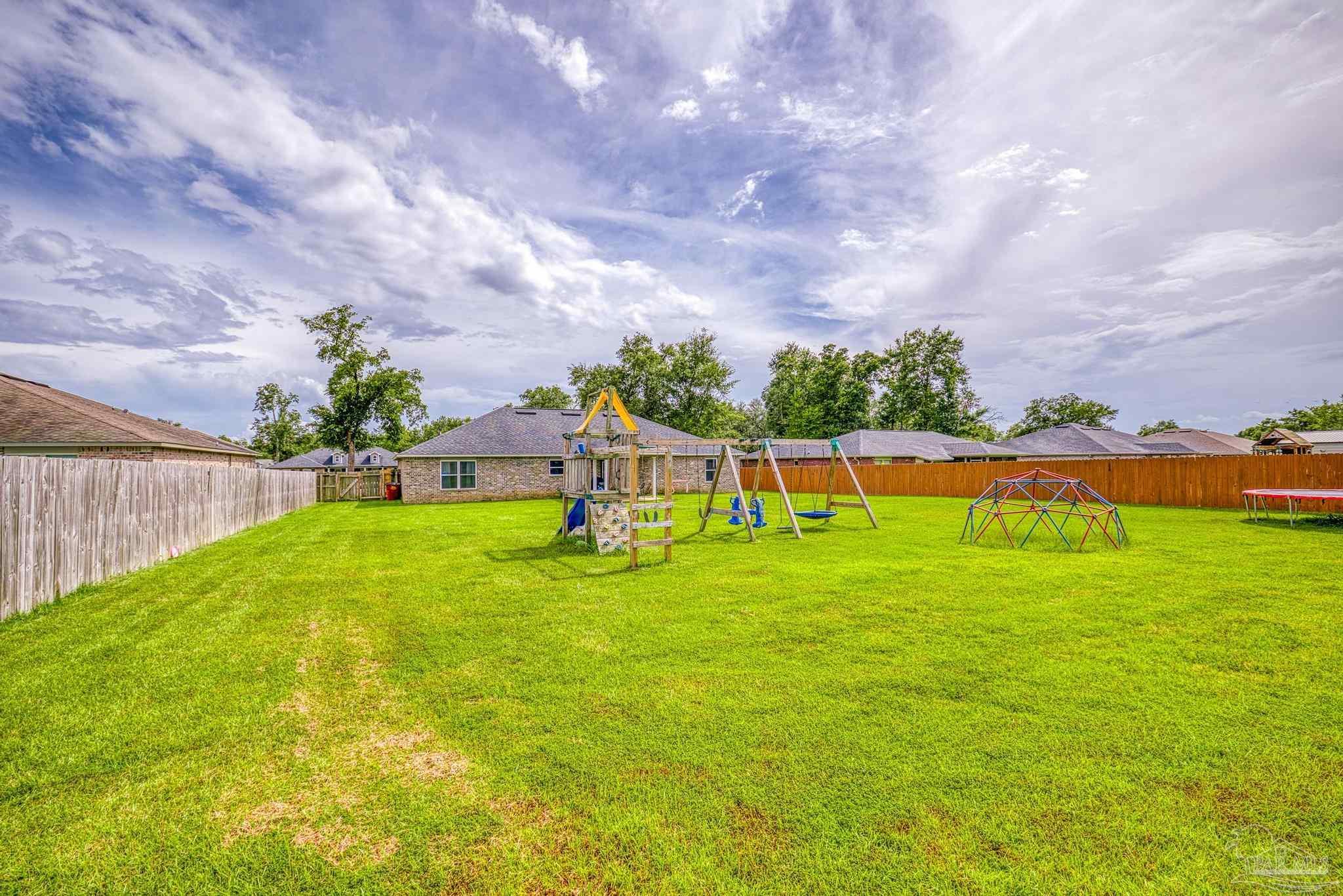 4037 Millwright Way Pace, FL 32571 - Photo 43 of 46 a view of yard with swimming pool and green space
