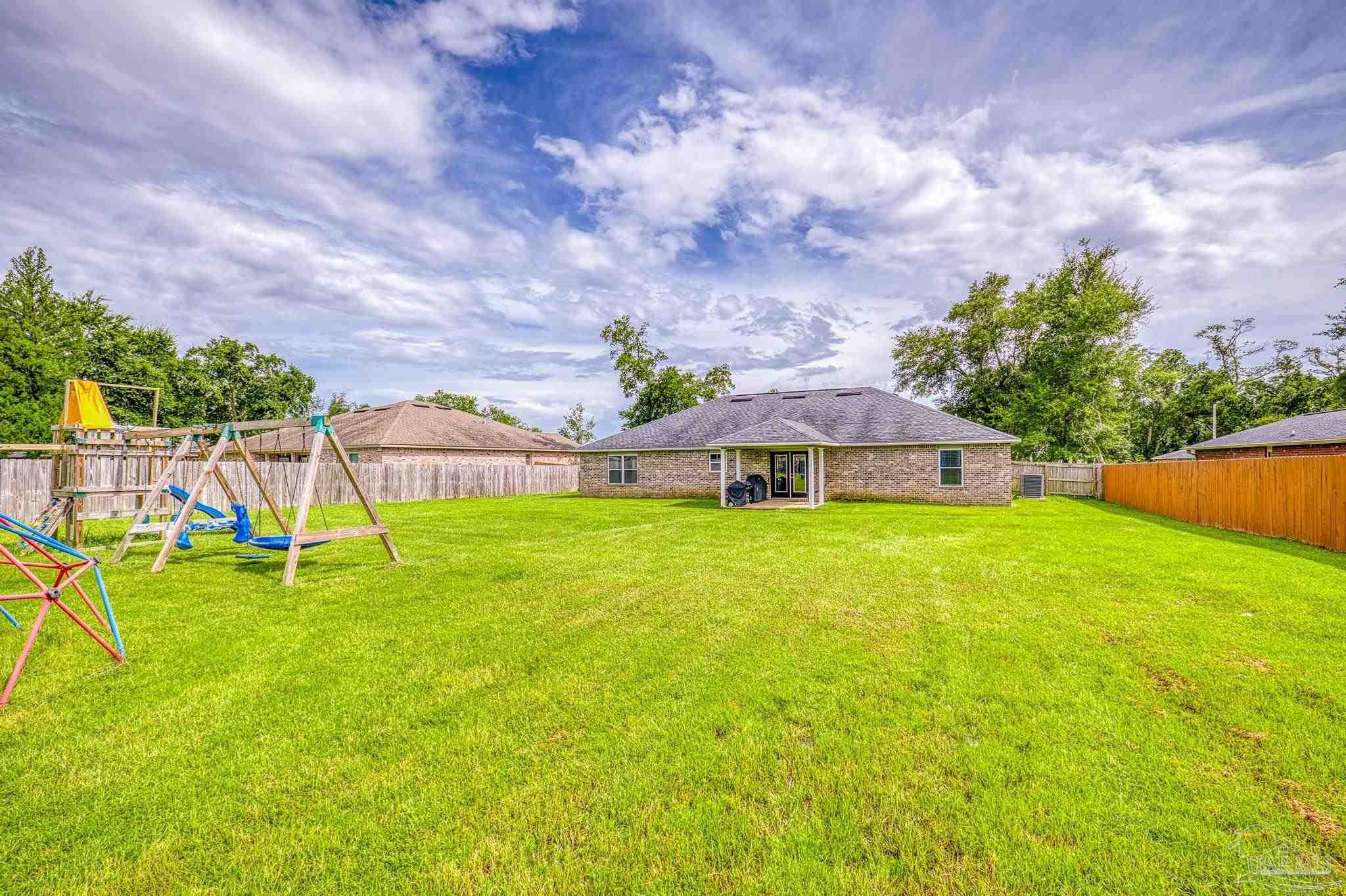 4037 Millwright Way Pace, FL 32571 - Photo 45 of 46 a view of a house with a big yard and a big yard