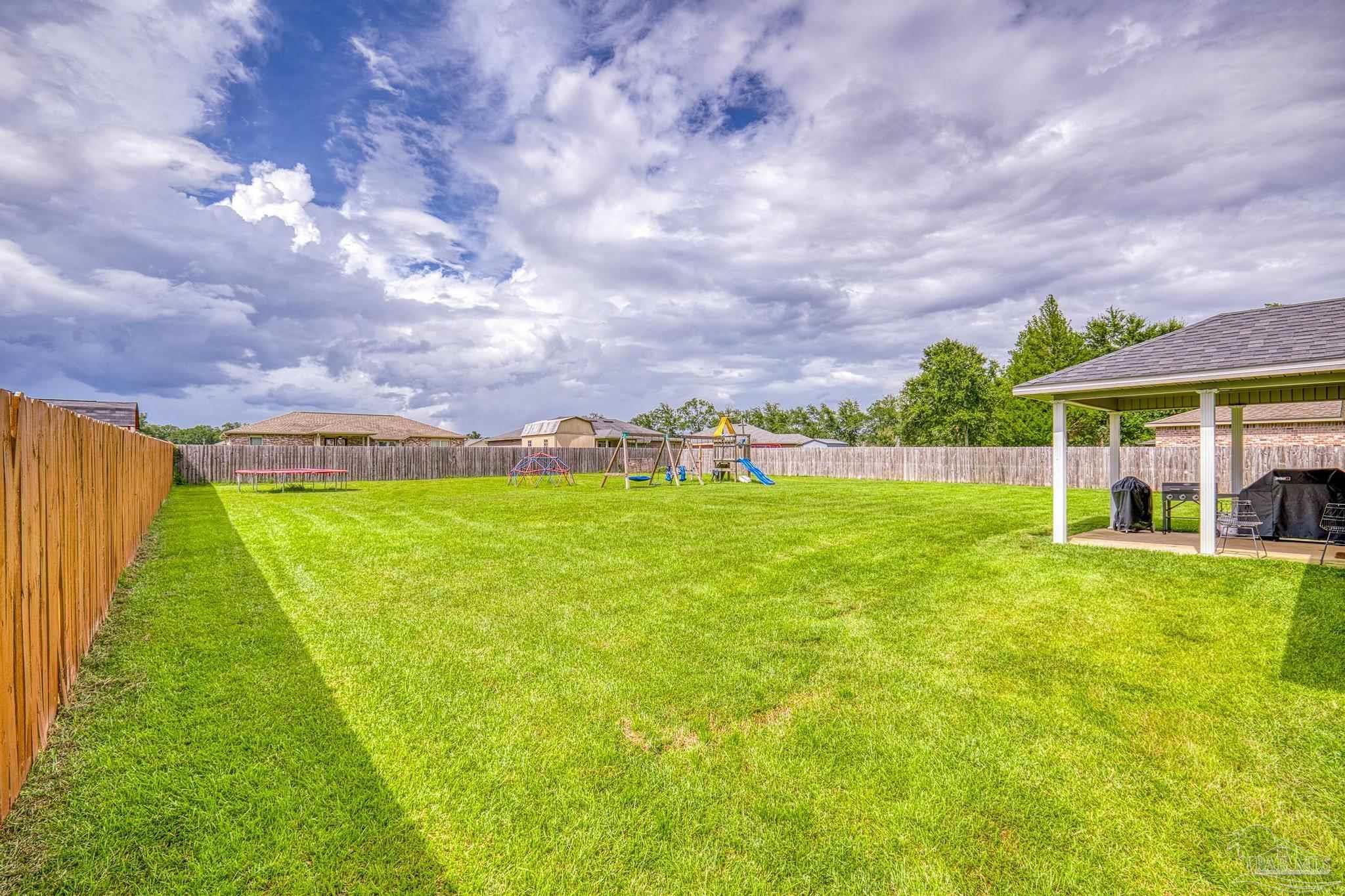 4037 Millwright Way Pace, FL 32571 - Photo 46 of 46 a view of yard with swimming pool and green space