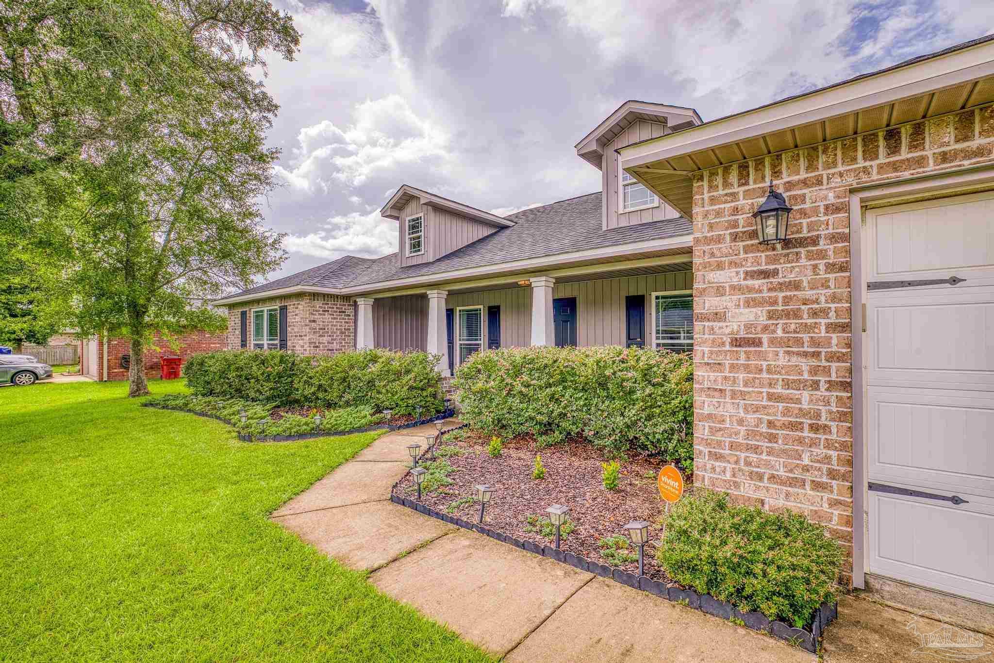 4037 Millwright Way Pace, FL 32571 - Photo 5 of 46 a front view of a house with a yard