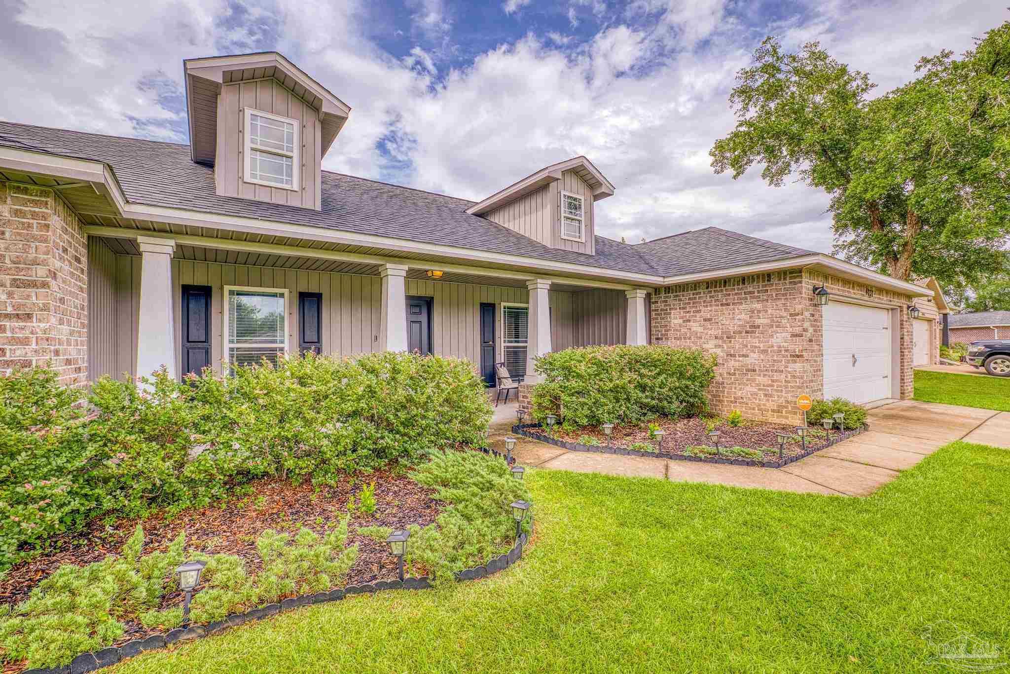 4037 Millwright Way Pace, FL 32571 - Photo 6 of 46 a front view of a house with a yard