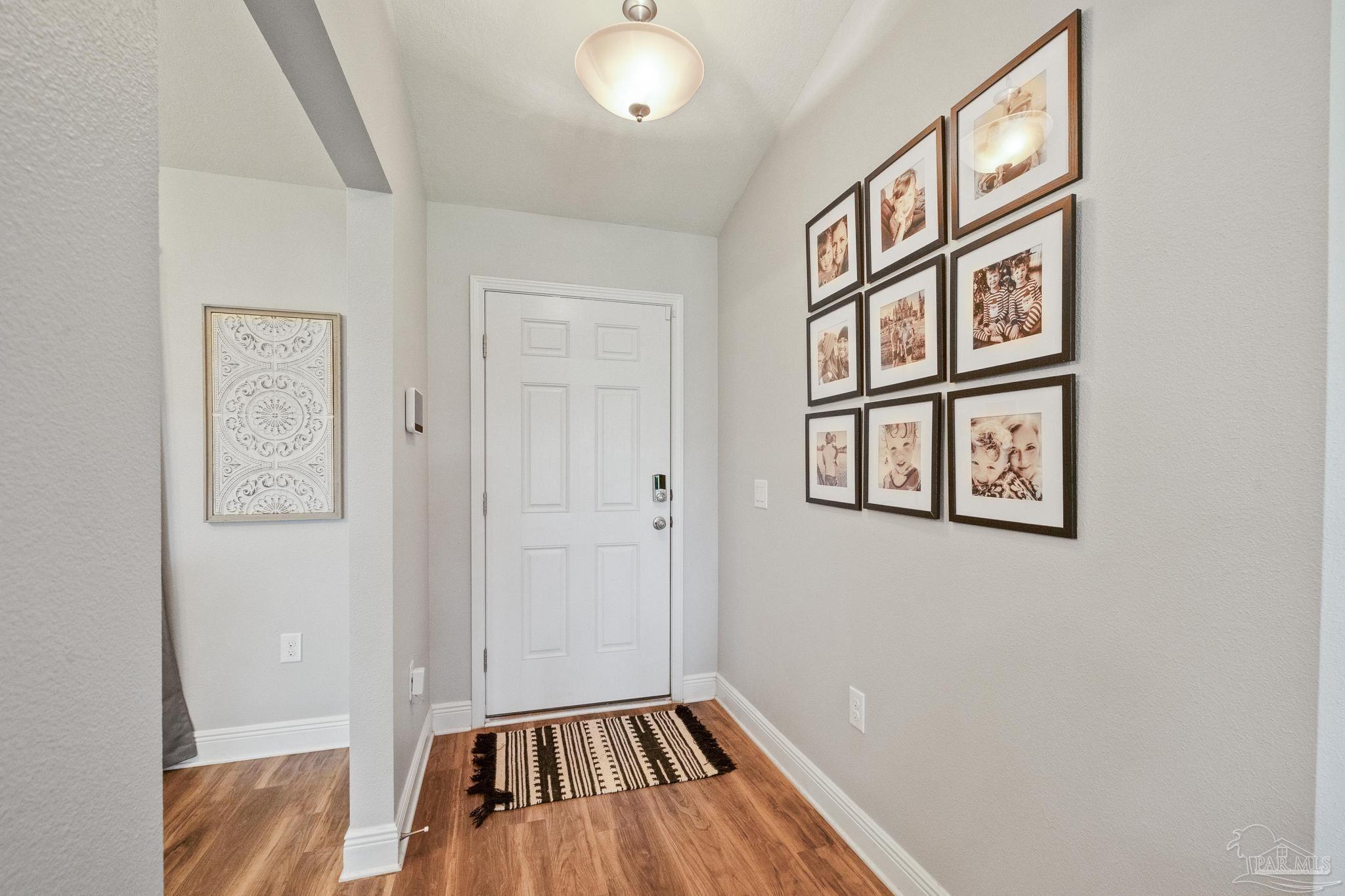 4037 Millwright Way Pace, FL 32571 - Photo 10 of 46 a view of an entryway with wooden floor