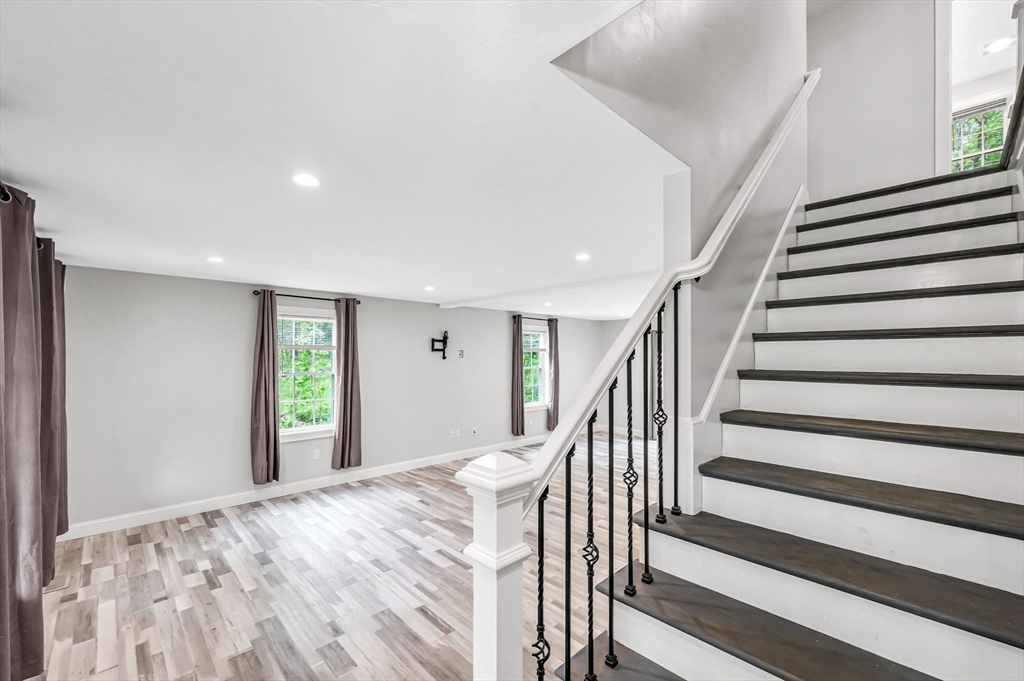 1310 North Brookfield Road Oakham, MA 01068 - Photo 11 of 30 a view of a bedroom with wooden floor and stairs