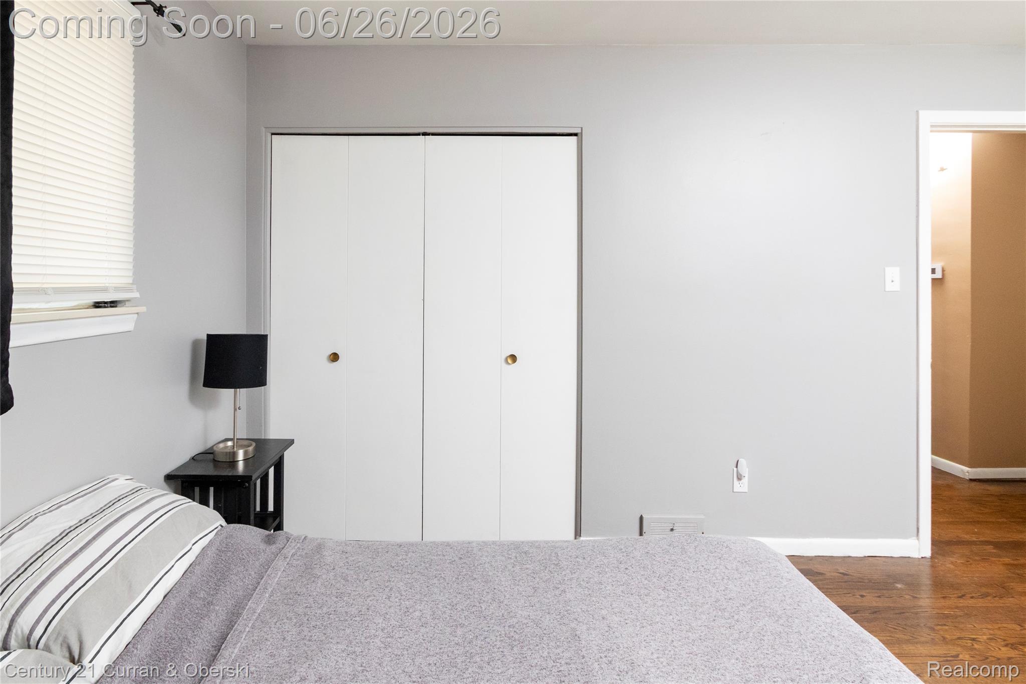 3220 Alice Street Dearborn, MI 48124 - Photo 23 of 39 Room with light gray walls, white baseboards, and wood-finish flooring