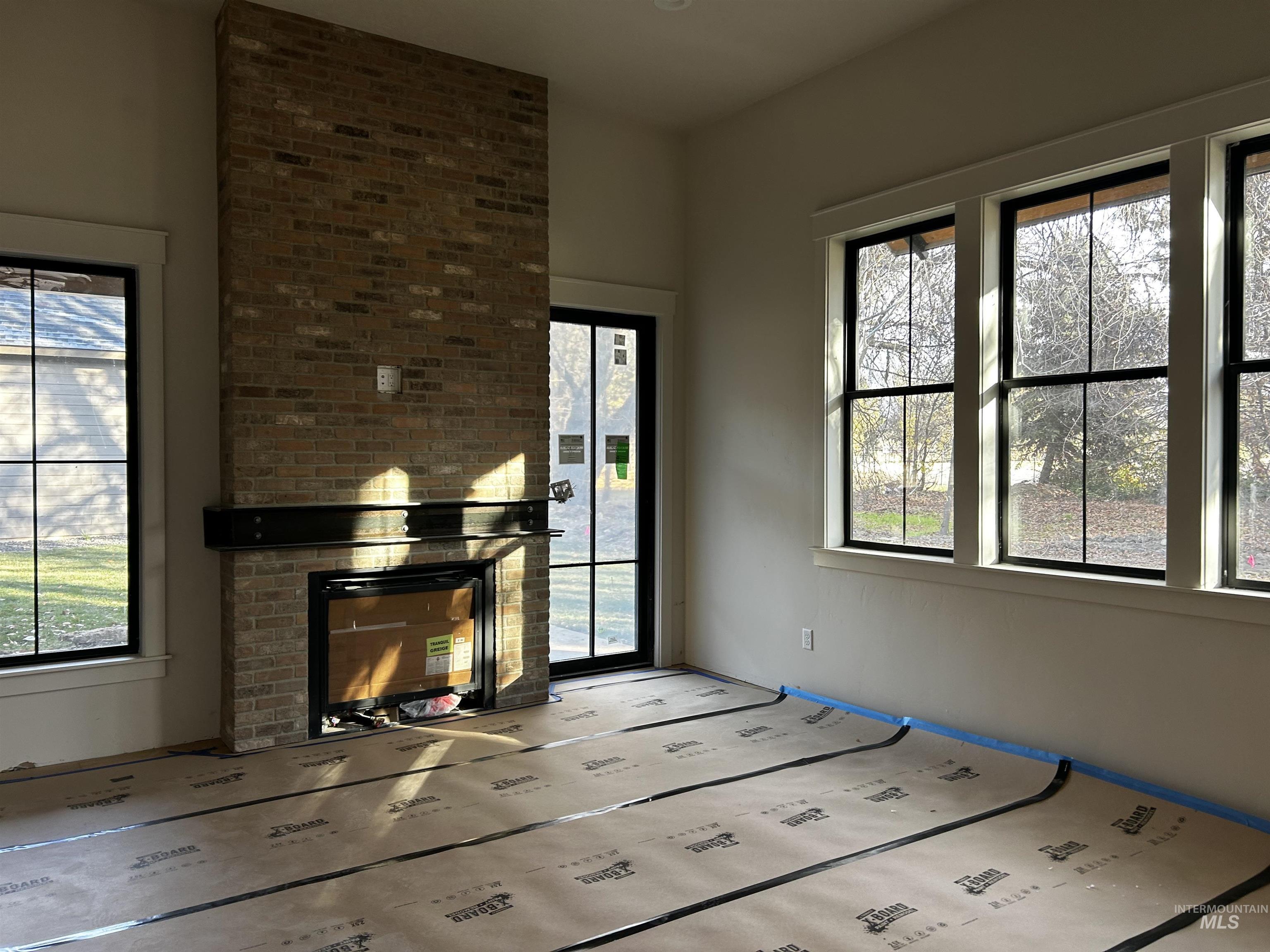 134 South Carbon Rivet Avenue Eagle, ID 83616 - Photo 12 of 20 Fireplace, hardwood flooring, door to covered patio and private backyard.