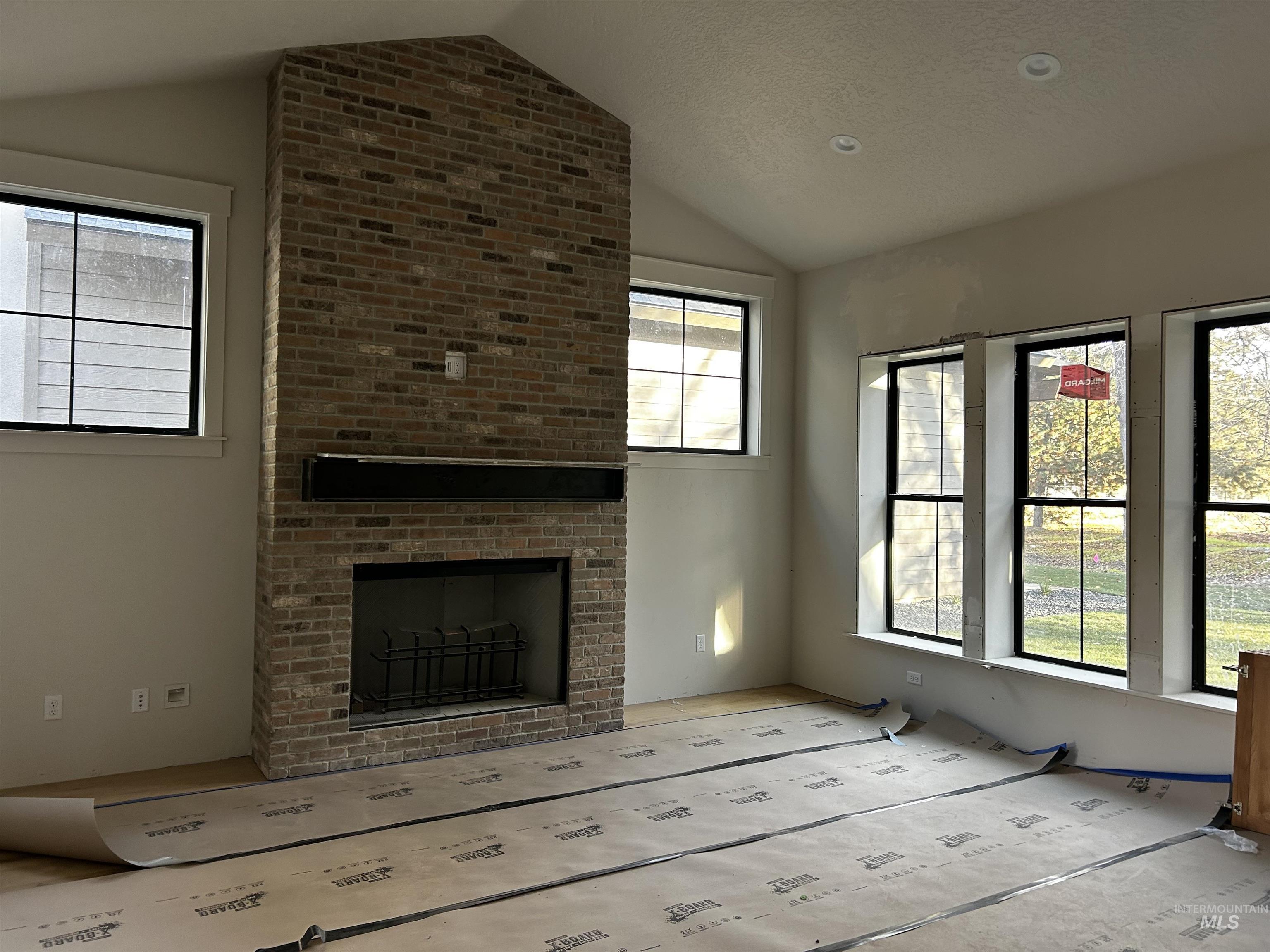 134 South Carbon Rivet Avenue Eagle, ID 83616 - Photo 9 of 20 Large wood burning fireplace with gas logs, hardwood floors installed and covered.