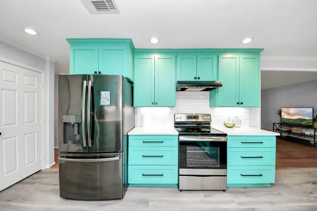 a kitchen with stainless steel appliances a refrigerator and a sink