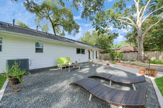 a view of backyard with outdoor seating and green space