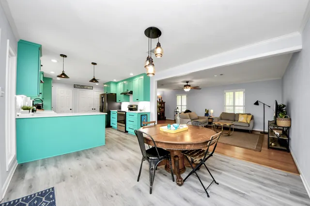 a dining room with furniture and wooden floor