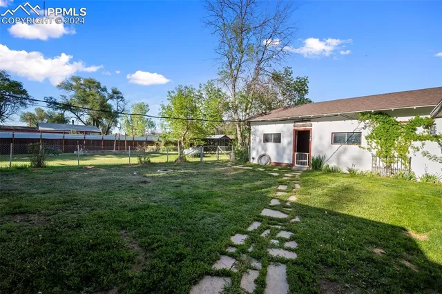 a view of a house with a yard porch and sitting area