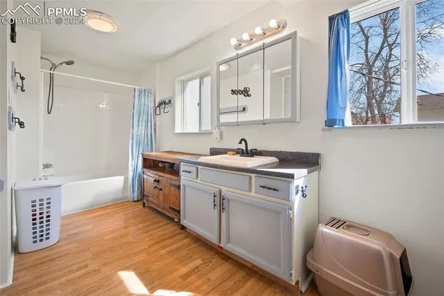 a kitchen with a sink cabinets and wooden floor
