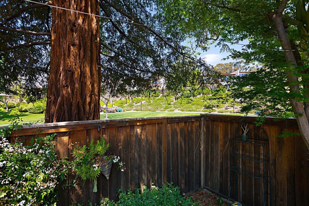595 Racquet Club Lane Thousand Oaks, CA 91360 - Photo 22 of 23 a view of a backyard with plants and wooden fence