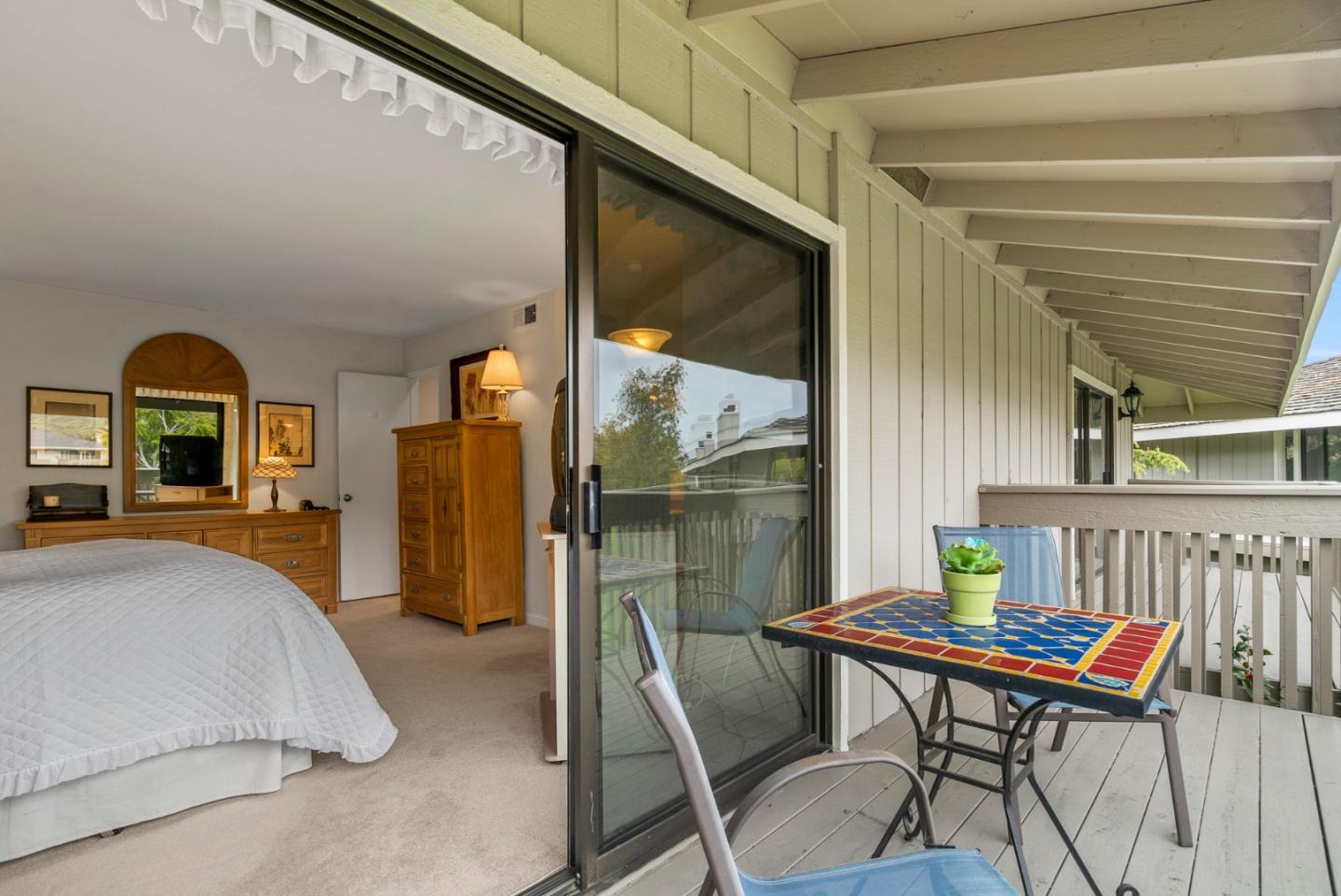 3850 Rio Road, Unit 21 Carmel, CA 93923 - Photo 12 of 31 a bedroom with a bed and large window with balcony view