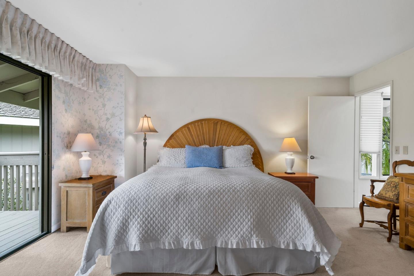 3850 Rio Road, Unit 21 Carmel, CA 93923 - Photo 13 of 31 a bedroom with a bed and a potted plant on the dresser