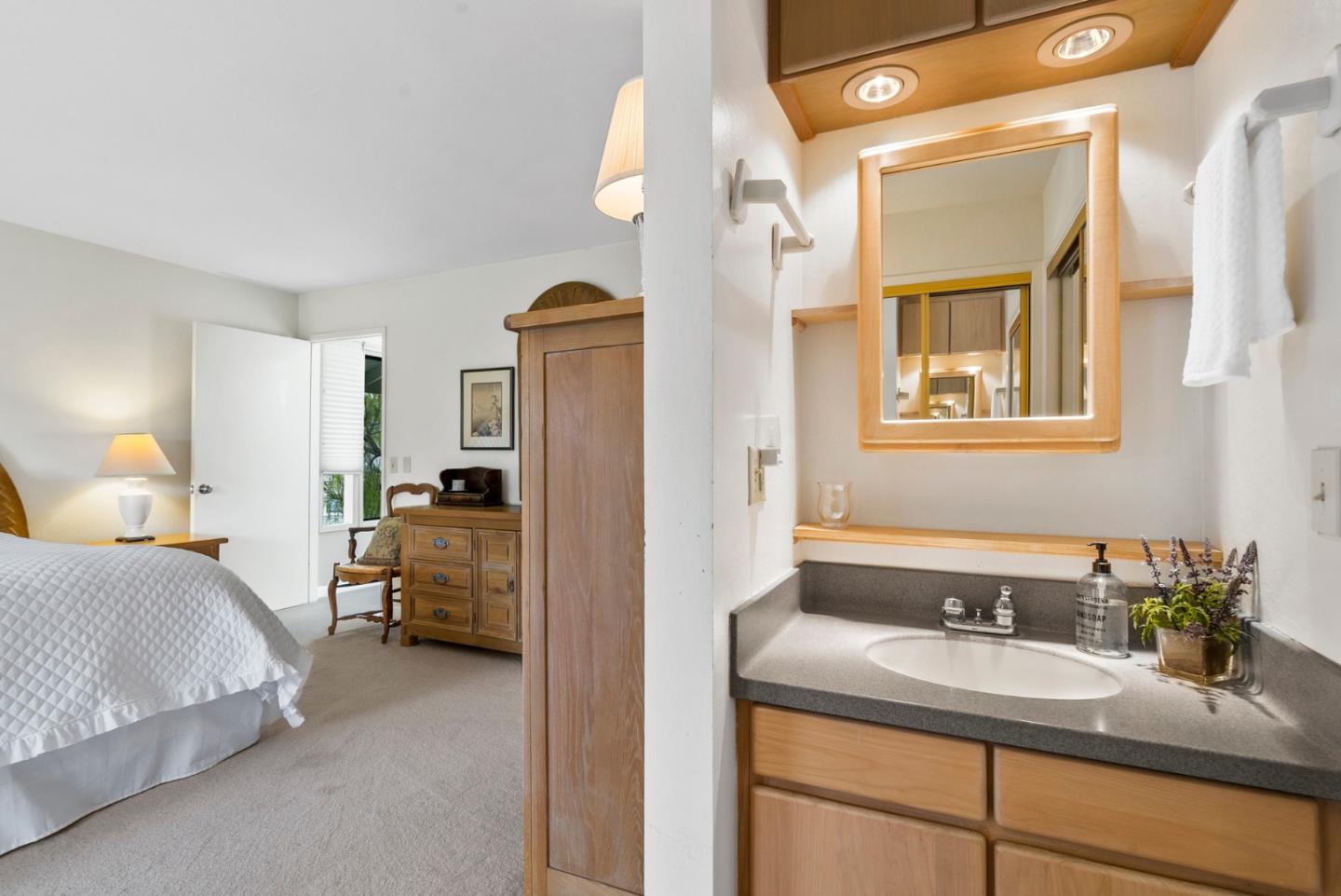 3850 Rio Road, Unit 21 Carmel, CA 93923 - Photo 14 of 31 a en suite bathroom with a sink and a mirror