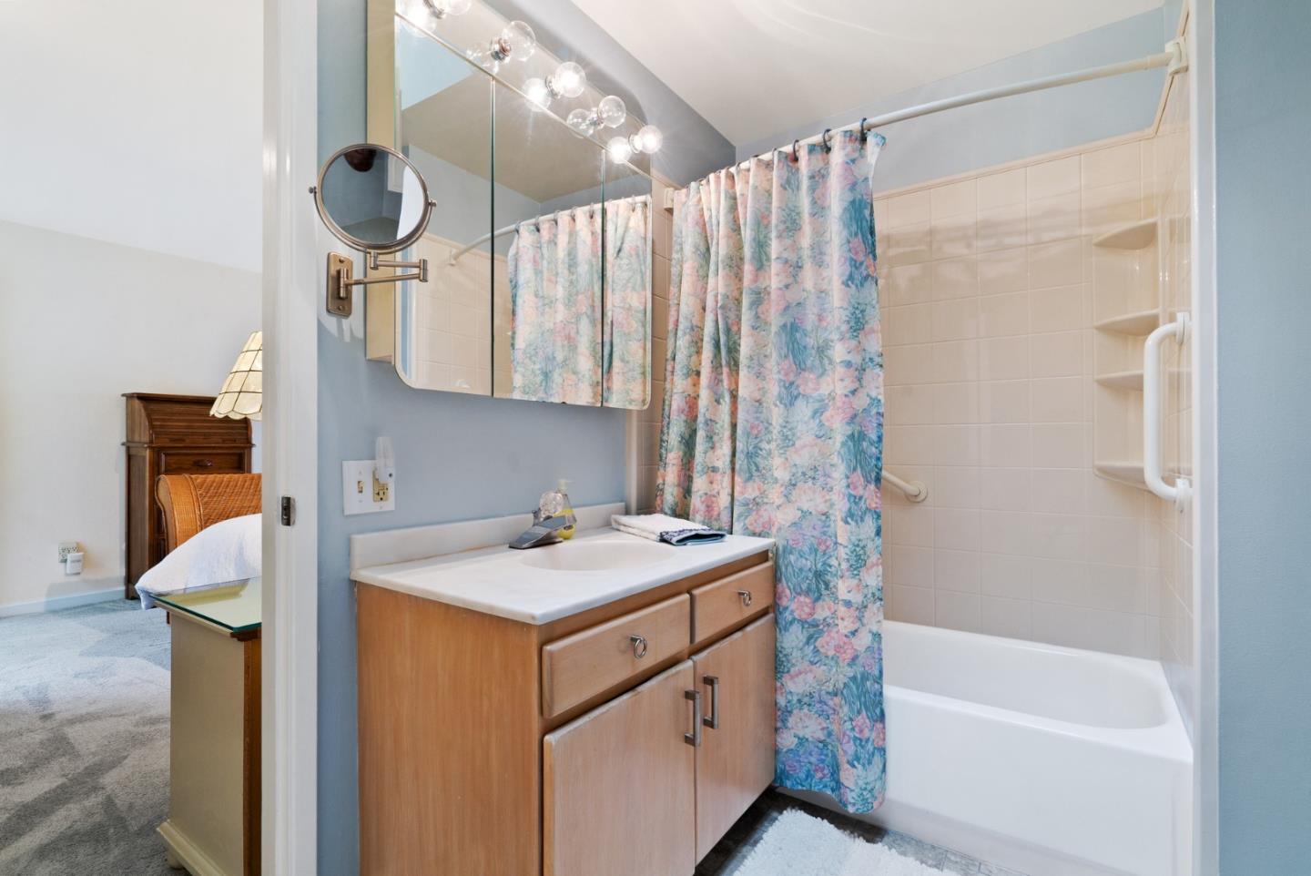 3850 Rio Road, Unit 21 Carmel, CA 93923 - Photo 20 of 31 a bathroom with a sink a mirror and a shower