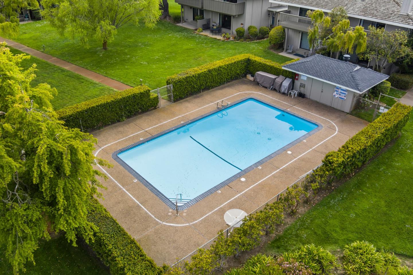 3850 Rio Road, Unit 21 Carmel, CA 93923 - Photo 25 of 31 a view of a tennis ground with a large pool