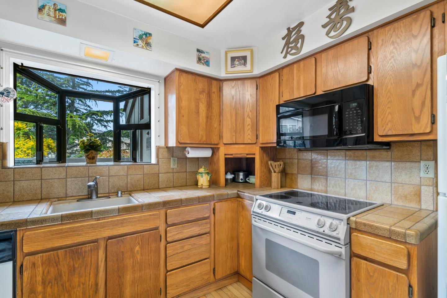 3850 Rio Road, Unit 21 Carmel, CA 93923 - Photo 7 of 31 a kitchen with a stove microwave and sink