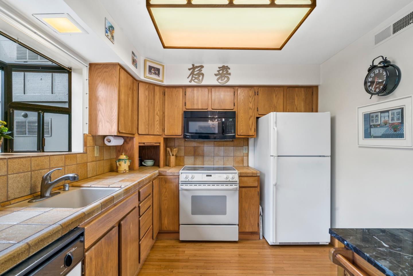 3850 Rio Road, Unit 21 Carmel, CA 93923 - Photo 8 of 31 a kitchen with a refrigerator sink and stove