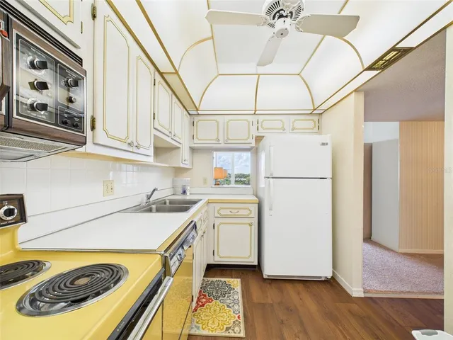 a kitchen with stainless steel appliances a stove a refrigerator and cabinets