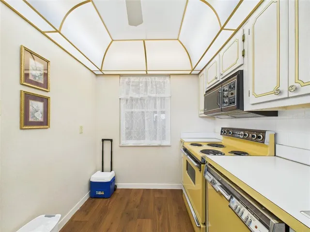 a spacious bedroom with a bed and large windows