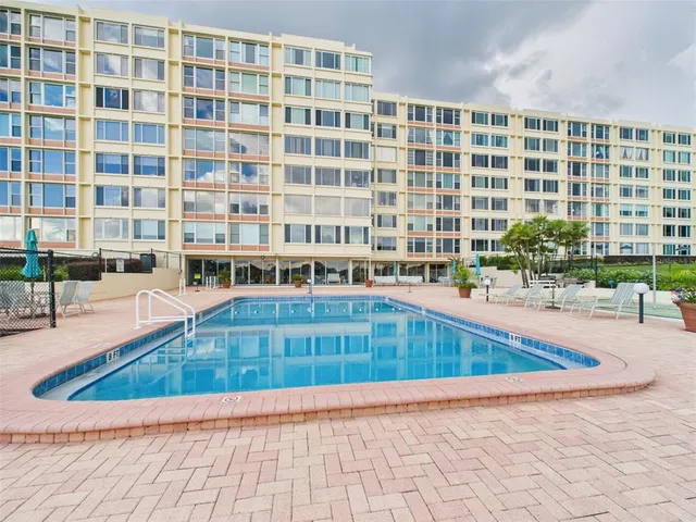 a utility room with cabinets washer and dryer