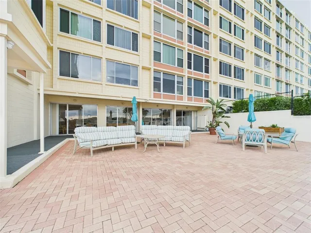 a living room with lots of furniture and a book shelf