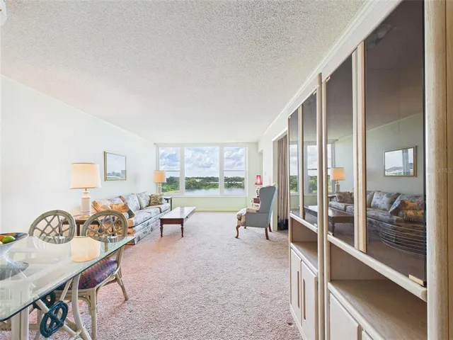 a living room with furniture and a floor to ceiling window