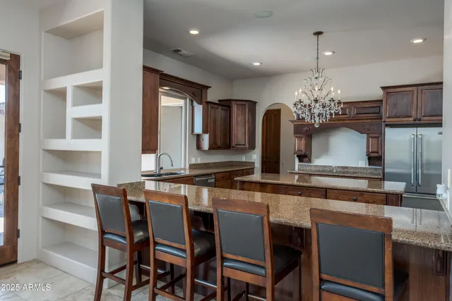 a view of empty room with windows and flat screen tv