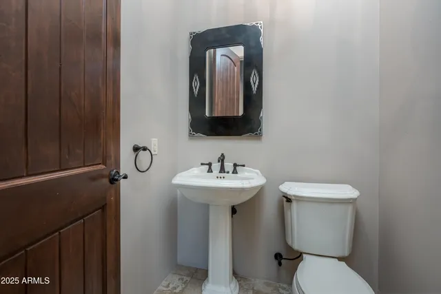 a bathroom with a granite countertop sink a toilet and shower