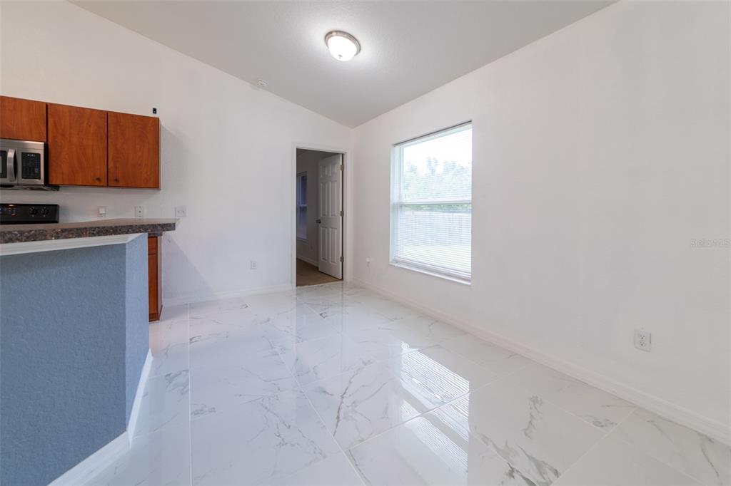 5107 Southwest 165th St Road Ocala, FL 34473 - Photo 10 of 34 a view of a kitchen with a sink and a window